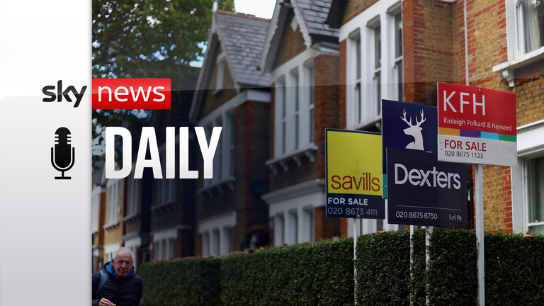 A man walks past houses ‘For Sale’ in a residential street in London