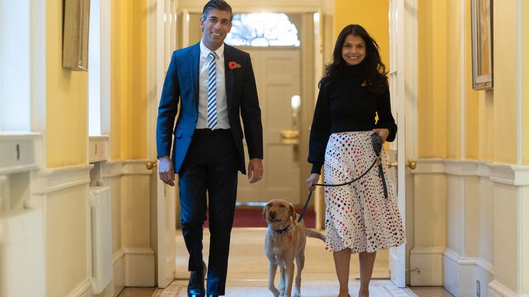31/10/2022. London, United Kingdom. The Prime Minister Rishi Sunak and his wife Akshata Murty buy poppies, and a special &#39;poppy&#39; dog collar for their pet Labrador Nova, from representatives of the Royal British Legion outside 10 Downing Street. Picture by Simon Walker / No 10 Downing Street

