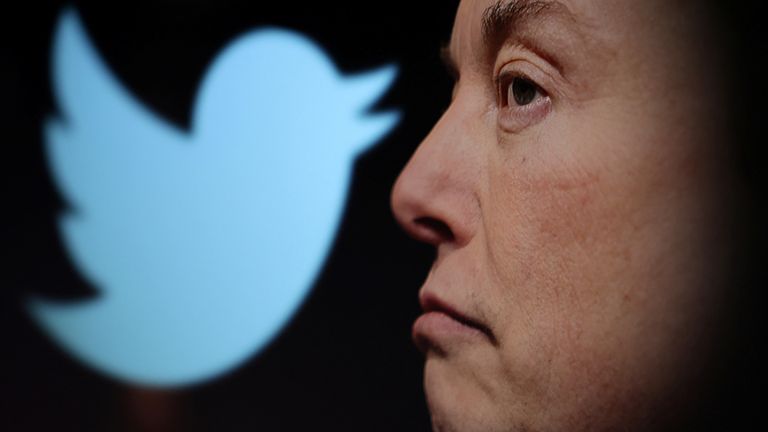 The Twitter logo and a photo of Elon Musk are shown enlarged in this photo taken on October 27, 2022.
