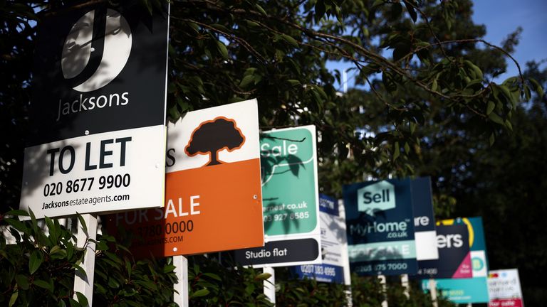Property estate agent sales and letting signs are seen attached to railings outside an apartment building in south London, Britain, September 23, 2021. REUTERS/Hannah McKay