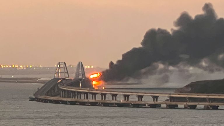 A view shows a fire on the Kerch bridge at sunrise in the Kerch Strait, Crimea, October 8, 2022. REUTERS/Stringer
