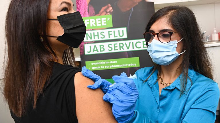 Pharmacists, Meera Sharma administers a flu vaccination to Lisa Taylor from West London at Superdrug&#39;s Strand branch, as the retailer is the first to provide 2022-23 NHS and private flu vaccinations on a high street, London. Picture date: Wednesday September 7, 2022.