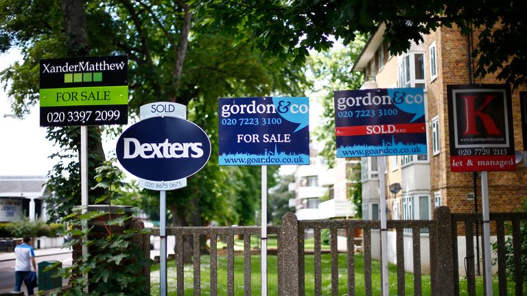Estate agents boards are lined up outside houses in south London, Britain June 3, 2014. REUTERS/Andrew Winning/File Photo
