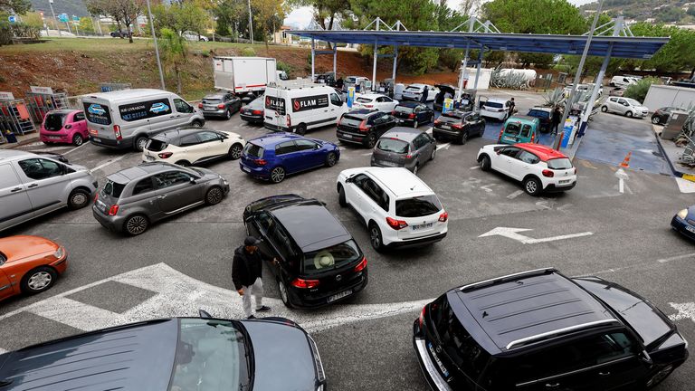 Cars queue to fill their fuel tanks at a petrol station in Nice