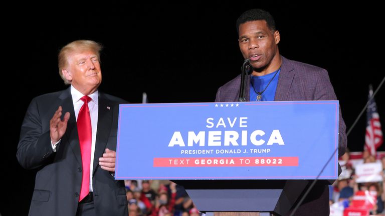 Herschel Walker at a rally alongside former US President Donald Trump in Perry, Georgia, last year