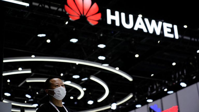 A person stands by a Huawei sign during the World Artificial Intelligence Conference, in Shanghai in September 2022