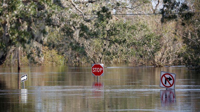 Traffic signs are seen on a flooded street after Hurricane Ian caused widespread destruction in Arcadia, Florida