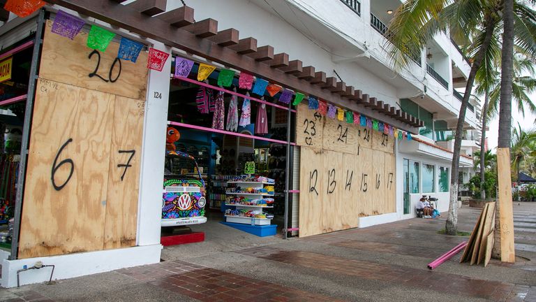 A store takes protective measures as Hurricane Roslyn approaches tourist zones along Mexico&#39;s Pacific coast