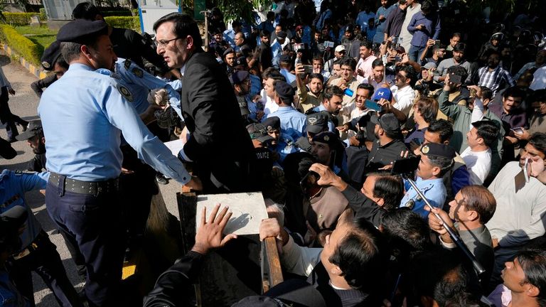 Police try to block Mr Khan&#39;s supporters from entering the Election Commission head office in Islamabad on Friday Pic: AP