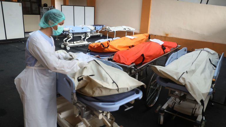 Pic: AP A medical worker puts identification tag on the bodies of the victims of a soccer stampede at the Saiful Anwar Hospital in Malang, East Java, Indonesia, Sunday, Oct. 2, 2022. Panic at an Indonesian soccer match after police fired tear gas to to disperse supporters invading the pitch left over 100 people dead, mostly trampled to death, police said Sunday. (AP Photo/Trisnadi)