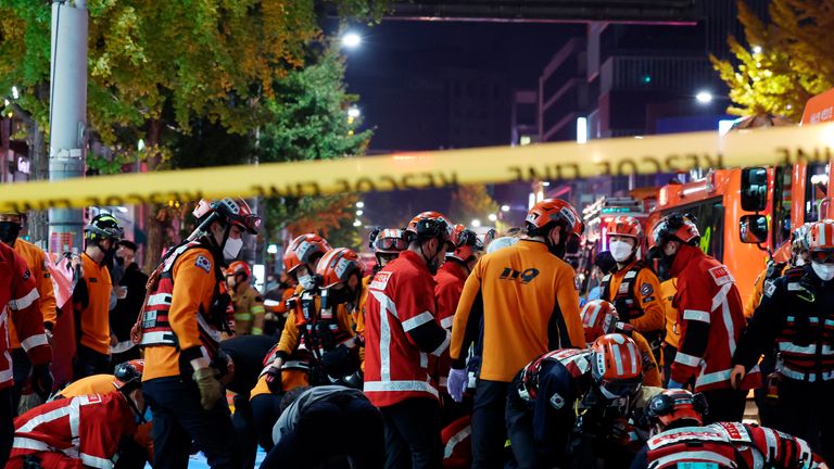 Rescue workers and firefighters work on the scene of a crushing accident in Seoul, South Korea, Saturday, Oct. 29, 2022. Pic: AP