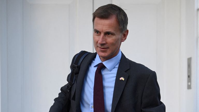 Britain&#39;s Chancellor of the Exchequer Jeremy Hunt walks outside his house in London, Britain, October 18, 2022. REUTERS/Toby Melville
