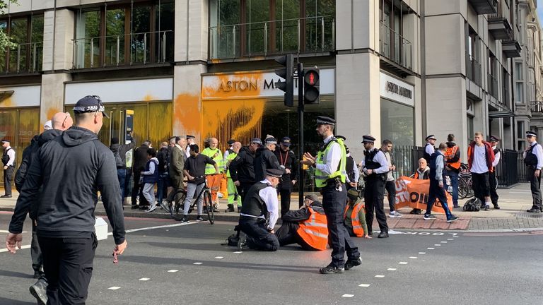 Protesters glue themselves down the street on Park Lane in central London