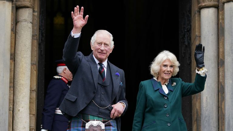 King Charles III and the Queen Consort wave as they leave Dunfermline Abbey, after a visit to mark its 950th anniversary, and after attending a meeting at the City Chambers in Dunfermline, Fife, where the King formally marked the conferral of city status on the former town. Picture date: Monday October 3, 2022.
