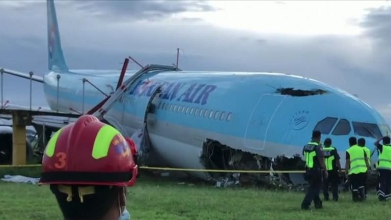 A damaged Korean Air plane remained stuck in the grass at a Philippine airport on Monday after it overshot a runway in rainy weather the night before.