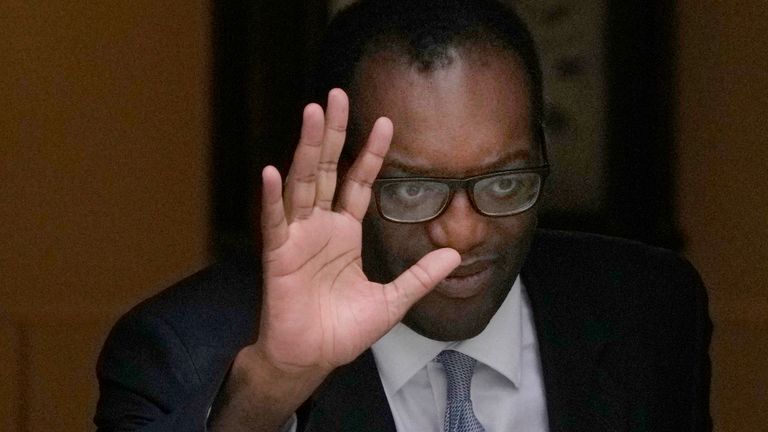 Kwasi Kwarteng waves to the media as he leaves 11 Downing Street after being sacked. Pic: AP