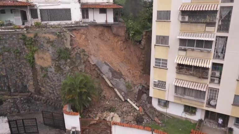 Land gives way from under building in Venezuela, crashing down into an apartment block