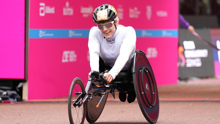 Switzerland&#39;s Catherine Debrunner celerbates winning the Women&#39;s Elite Wheelchair race 