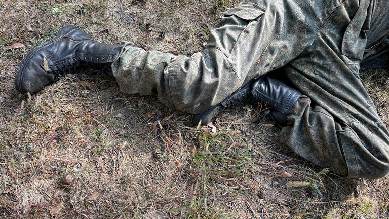 The legs of a fallen Russian soldier in Lyman