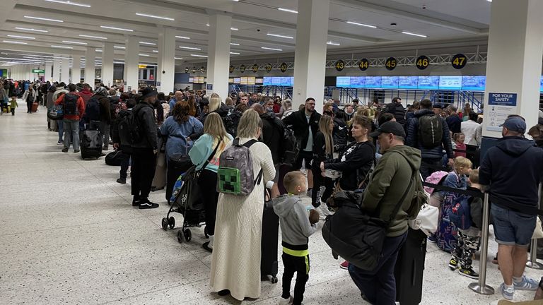 Passengers queue inside the departures area of Terminal 1 at Manchester Airport