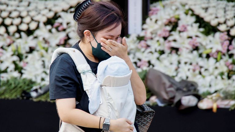 A person mourns at a group memorial for the victims of a stampede during a Halloween festival, at Seoul City Hall Plaza in Seoul, South Korea, October 31, 2022. REUTERS/Heo Ran