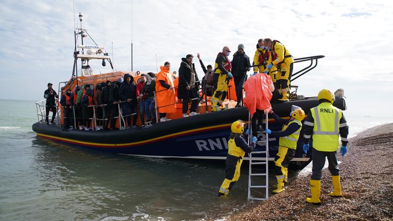 A group of people thought to be migrants are brought in to Dungeness beach by the Dungeness lifeboat following a small boat incident in the Channel. Picture date: Wednesday October 12, 2022.