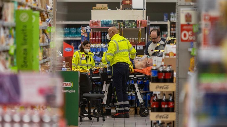 An injured person on a stretcher at the scene of an attack in Milan, Italy, Thursday Oct. 27, 2022. A man armed with a knife stabbed five people inside a shopping center south of Milan on Thursday. (LaPresse via AP)