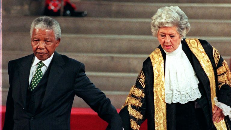 South African President Nelson Mandela is assisted by Speaker of the House Betty Boothroyd on July 11 as he arrives at the Palace of Westminster.  Mandela was a guest of Parliament when he addressed both houses of Parliament as part of his four-day State visit.