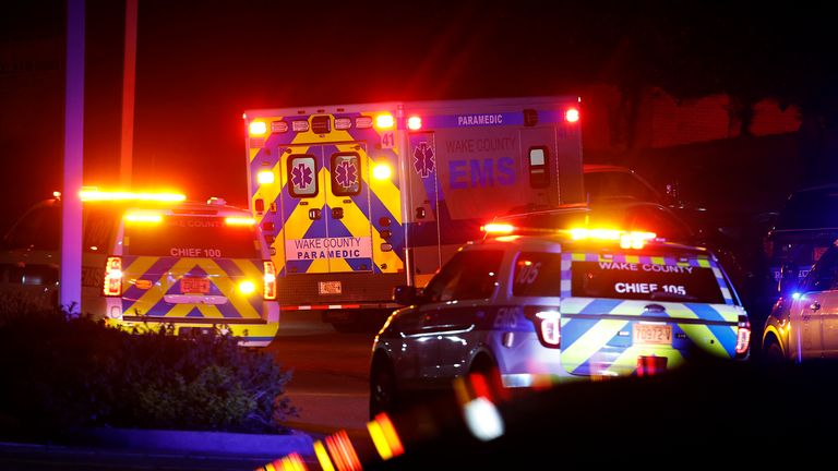 An ambulance believed to be carrying a shooting suspect arrives at Wake Medical Center Emergeny Room in Raleigh, N.C., Thursday, Oct. 13, 2022 surrounded by police. (AP Photo/Karl DeBlaker)