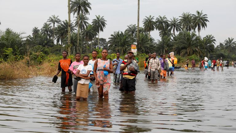 Residents wade through flood water in Obagi community, Rivers state, Nigeria October 21, 2022. REUTERS/Temilade Adelaja
