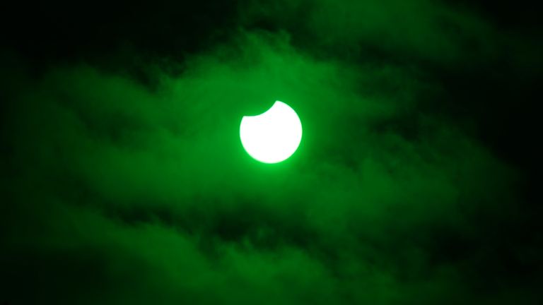 The moon passing in front of the sun during a partial eclipse viewed through glass from a welding visor at the Kelpies near Falkirk. Picture date: Tuesday October 25, 2022.