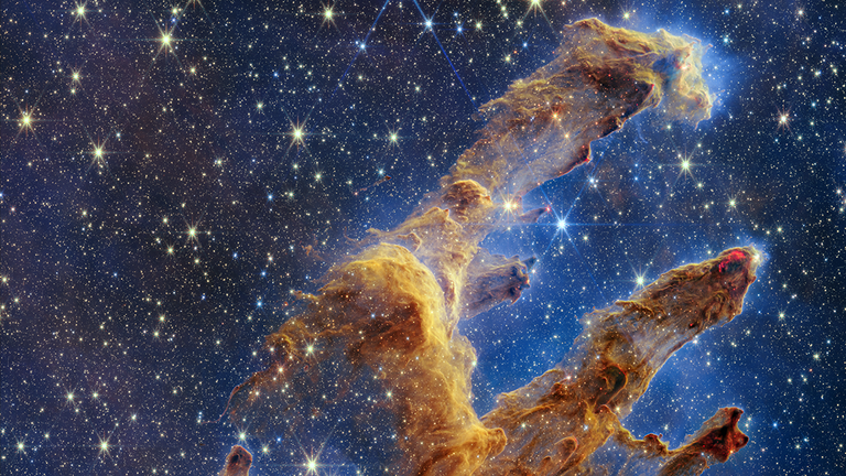 The Pillars of Creation are set off in a kaleidoscope of color in NASA’s James Webb Space Telescope’s near-infrared-light view. The pillars look like arches and spires rising out of a desert landscape, but are filled with semi-transparent gas and dust, and ever changing. This is a region where young stars are forming – or have barely burst from their dusty cocoons as they continue to form.
Credit:Nasa/ESA/CSA