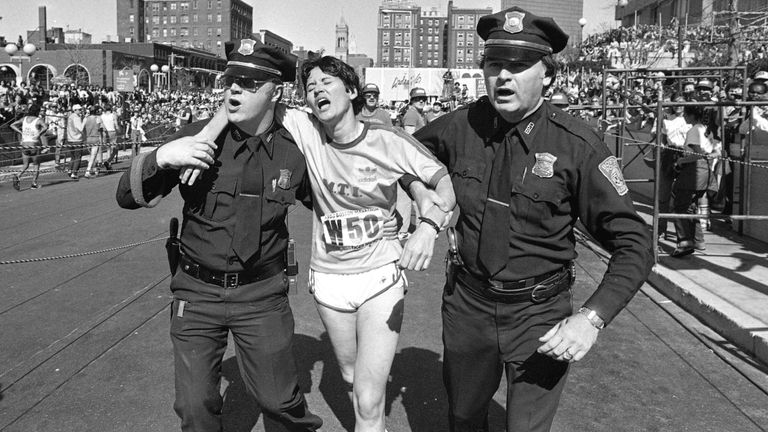 Rosie Ruiz, center, is assisted by Boston police after winning the women's portion of the Boston Marathon, April 21, 1980.  Record number 39 was set in 1979.  (AP Photo)