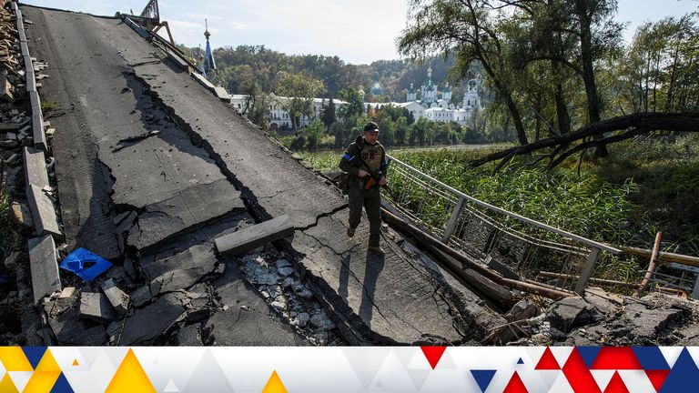 A service member of Ukraine&#39;s National Guard walks on a bridge over the Siverskyi Donets river destroyed during Russia&#39;s attack on Ukraine, in the town of Sviatohirsk, Donetsk region, Ukraine October 1, 2022.  REUTERS/Vladyslav Musiienko     TPX IMAGES OF THE DAY     