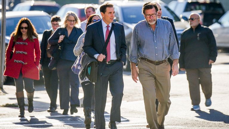 Bill Sherlach, front right, his slain wife Mary, and other plaintiffs and their attorneys arrive in court Wednesday