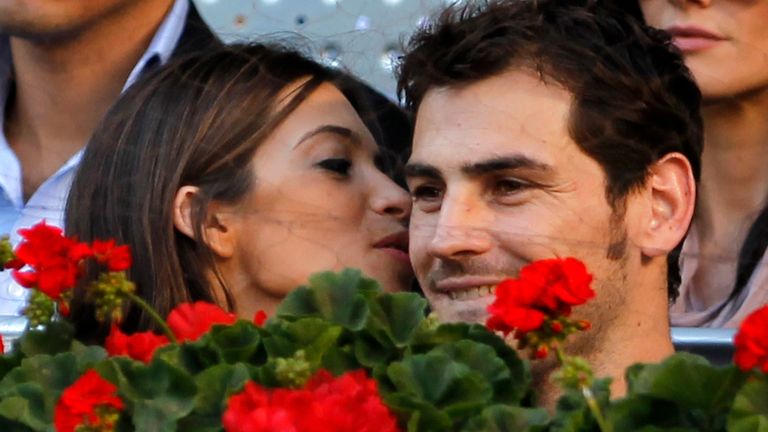 Real Madrid goalkeeper Iker Casillas (R) is kissed by his girlfriend television journalist Sara Carbonero during the Madrid Open final tennis match in Madrid May 8, 2011. REUTERS/Juan Medina (SPAIN - Tags: SPORT TENNIS)
