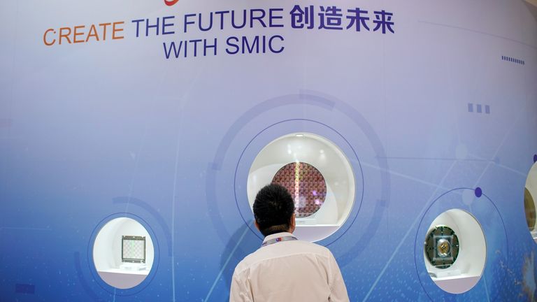 A man visits a booth of Semiconductor Manufacturing International Corporation (SMIC), at the China International Semiconductor Expo in October 2020