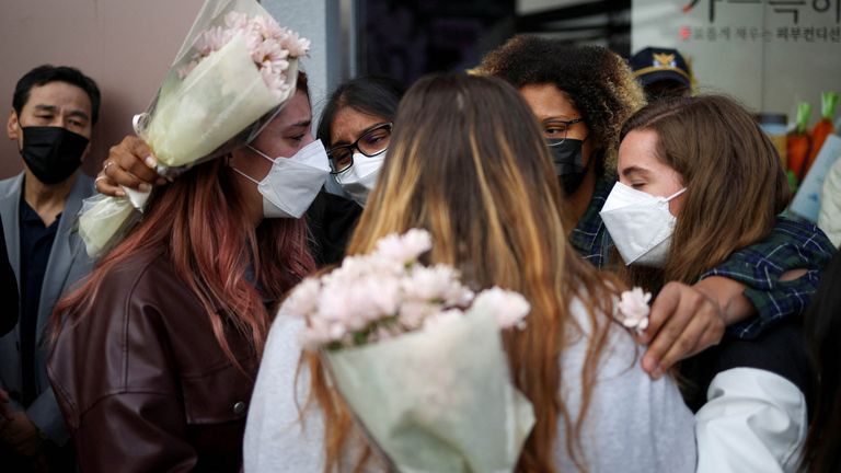 People react near the scene of a stampede that happened during Halloween festivities, in Seoul, South Korea, October 31, 2022. REUTERS/Kim Hong-Ji