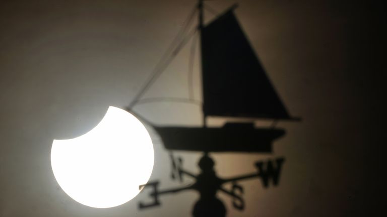 A partial solar eclipse visible over Cullercoats Watch House in North Shields. Picture date: Tuesday October 25, 2022.
