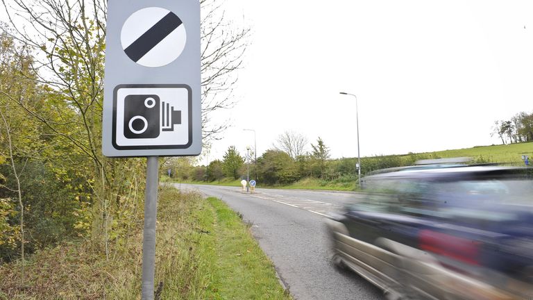 A warning about traffic cameras being used on a road