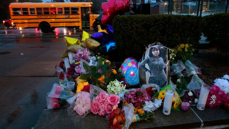 A photo of Alexandria Bell rests at the scene of a growing floral memorial to the victims of a school shooting at Central Visual & Performing Arts High School, Tuesday, Oct. 25, 2022, in St. Louis. Bell and teacher Jean Kuczka were killed, along with the gunman, in Monday&#39;s shooting. (Robert Cohen/St. Louis Post-Dispatch via AP)