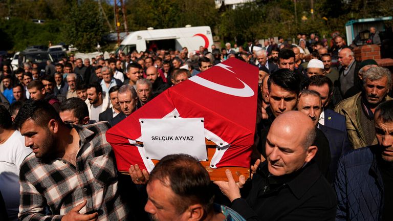Turkish interior minister Suleyman Soylu, right, helps carry a coffin of one of the miners killed in the explosion Pic: AP 