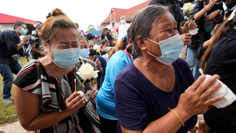 Relatives pray during a ceremony for those killed in the attack on the Young Children&#39;s Development Center