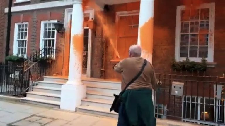 Environmental protesters blocked a road and sprayed orange paint on a building housing several lobby groups.