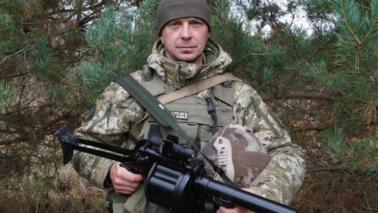 A Ukrainian border guard displays a grenade launcher they are equipped with. 