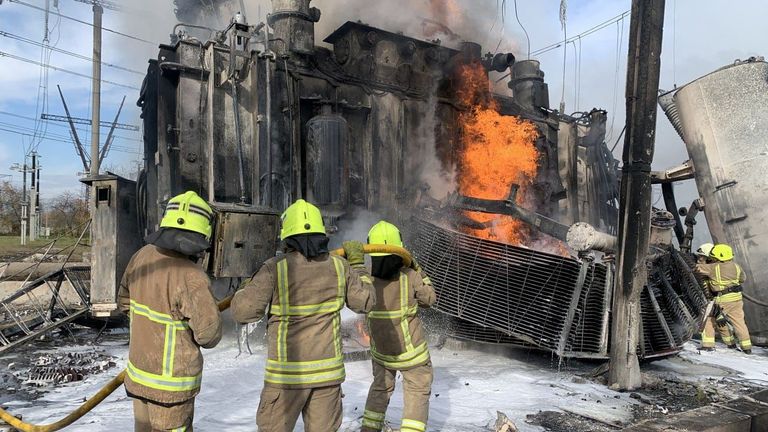 Firefighters work to put out a fire at energy infrastructure facilities