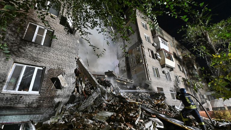 A rescue worker at a destroyed residential building in Zaporizhzhia