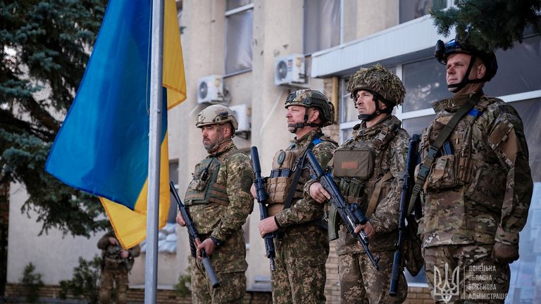 Ukrainian service members attend a flag raising ceremony in the town of Lyman, recently liberated by the Ukrainian Armed Forces, amid Russia&#39;s attack on Ukraine, in Donetsk region, Ukraine October 4, 2022. Press service of the Donetsk Regional Military-Civil Administration/Handout via REUTERS ATTENTION EDITORS - THIS IMAGE HAS BEEN SUPPLIED BY A THIRD PARTY. NO RESALES. NO ARCHIVE. DO NOT OBSCURE LOGO.

