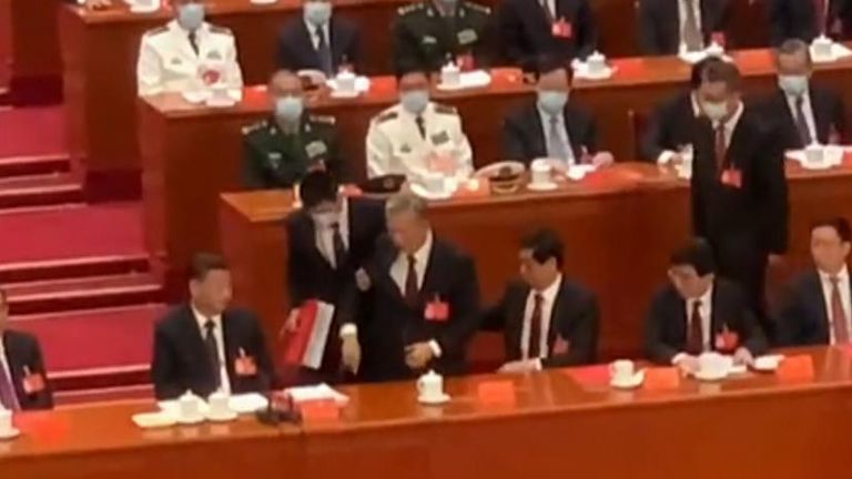 Hu Jintao, China&#39;s former president is escorted out of a closing ceremony for the Communist Party. Mr Jintao appeared to be reluctant to leave, trying to talk to President Xi Jinping while being led out. 