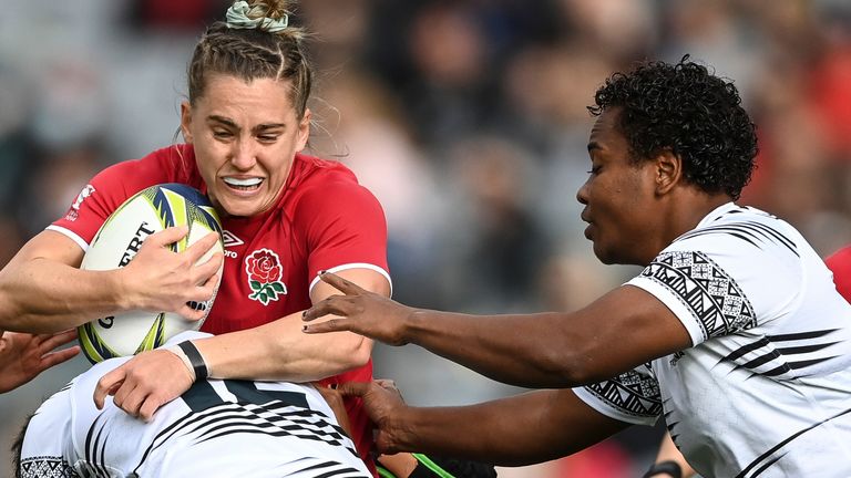 Claudia MacDonald of England is tackled by defenders during the Women&#39;s Rugby World Cup pool match between England and Fiji, at Eden Park, Auckland, New Zealand, Saturday, Oct.8. 2022. (Andrew Cornaga/Photosport via AP)